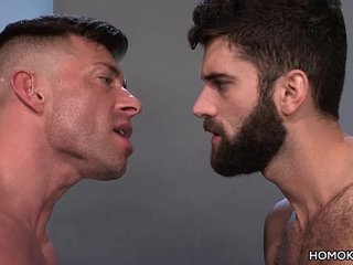 Muscular men sharing the ass of a bearded guy